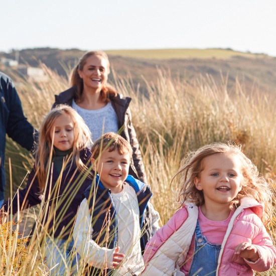 Familie bei Spaziergang in der Sonne; © Monkey Business Images - Shutterstock